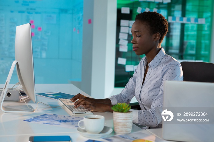 Female executive working on computer at desk