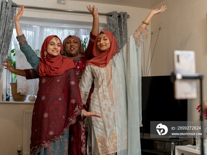 Women posing for picture during Ramadan celebration at home