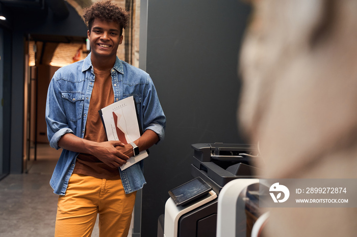 Man standing near the printer machine