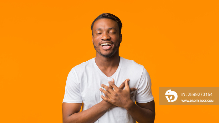 Afro Guy Holding Hands On Chest Standing In Studio, Panorama