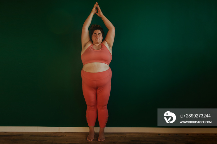 plus size woman does yoga pose