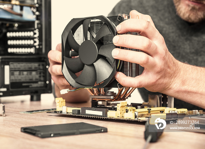 Computer technician installs cooling system.