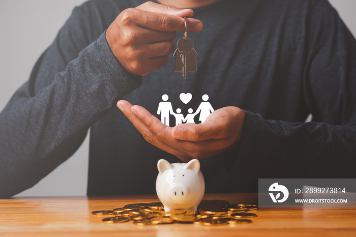 Businessman with coin, piggybank, hold key house and icon family on table, donation, saving, charity, family finance plan concept, fundraising, superannuation, investment, financial crisis.