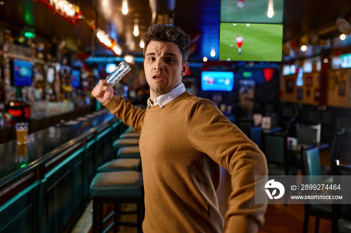 Angry man attacking with empty beer bottle