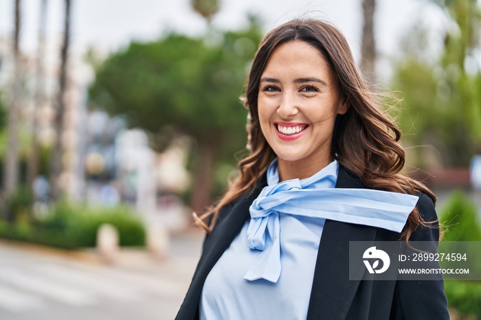 Young hispanic woman smiling confident standing at park