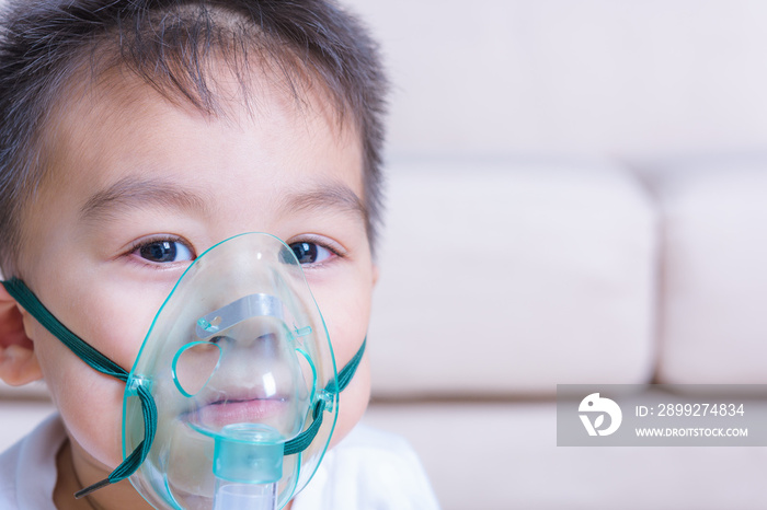 Closeup asian face little children boy using steam inhaler nebulizer mask inhalation