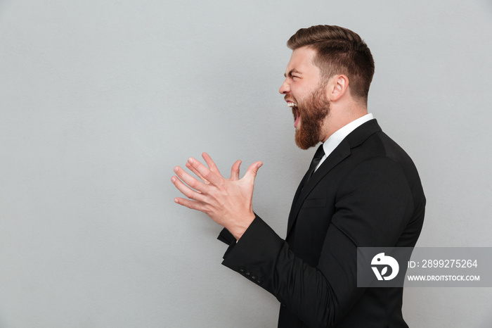 Man in suit shouting and gesturing with hands