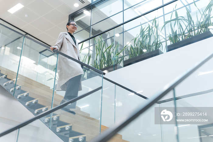 Non binary office worker walking on steps