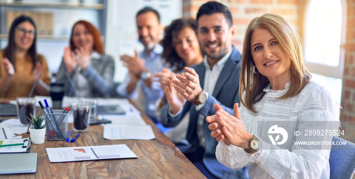 Group of business workers smiling happy and confident. Working together with smile on face looking at the camera applauding at the office