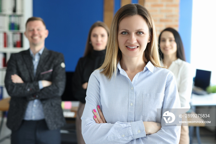 Portrait of confident business woman behind business team