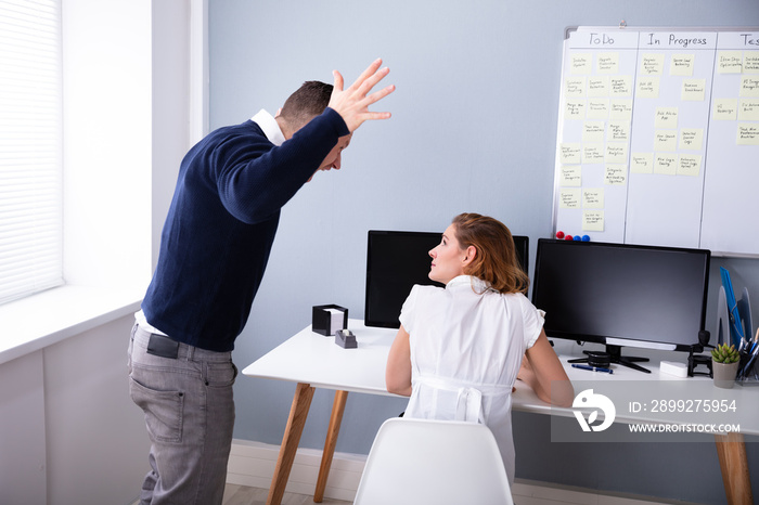 Angry Businessman Shouting At Female Executive