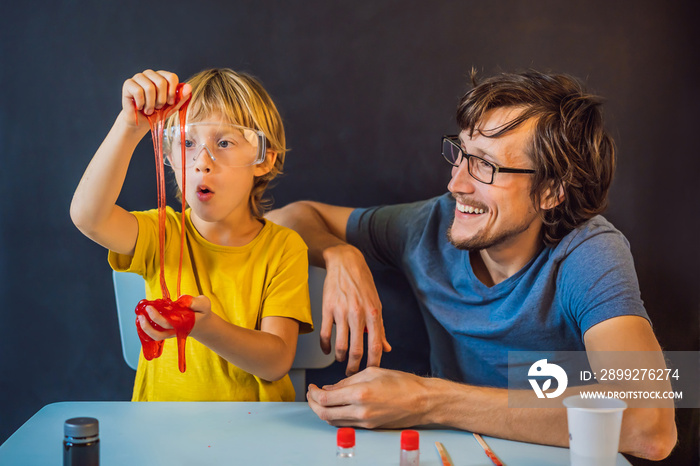 Father and son conduct chemical experiments at home. Home made slime. Family plays with a slime