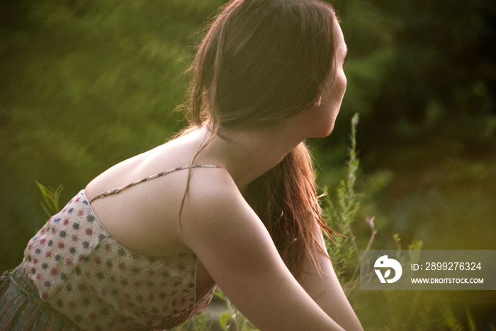 Side view of young woman in field