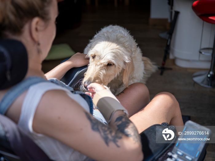 Woman in electric wheelchair with dog