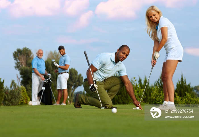 Female golfer learning to putt