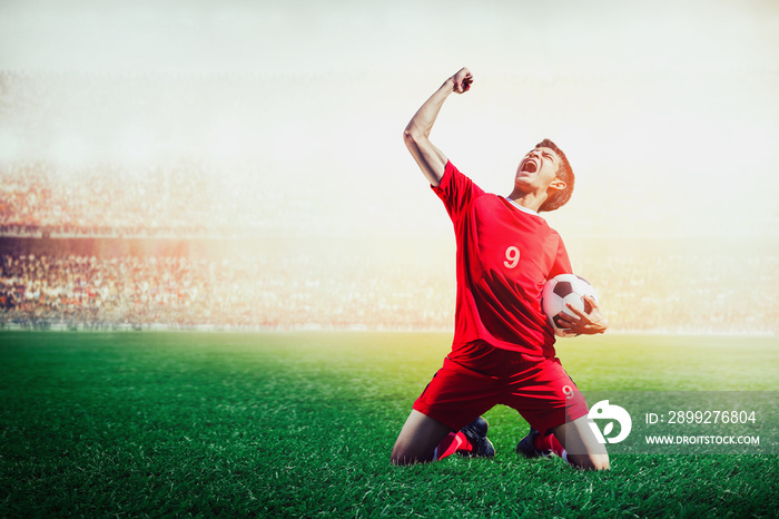 striker soccer football player in red team concept celebrating goal in the stadium during match