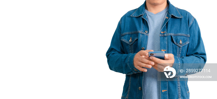 Asian man in shirt and jeans holding mobile phone