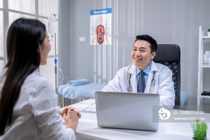 Asian male doctor counseling female patient on maintaining her health.