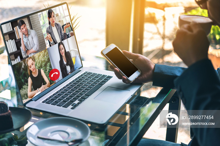 Businessman meeting by video conference with his team on laptop screen talking and discussion about financial.Working from home, Working remotely during covid-19 or corona virus crisis.