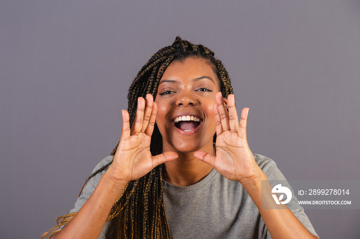 Young afro woman brazilian shouting with hands, promotion, announcing discount. called.