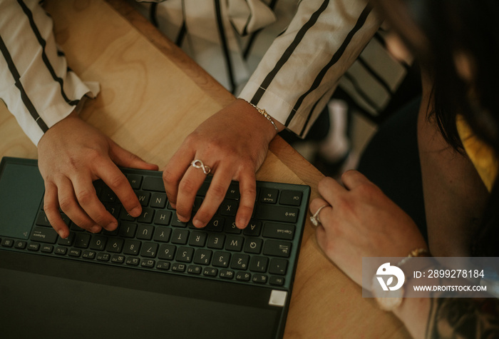 closeup of hands on laptop keyboard