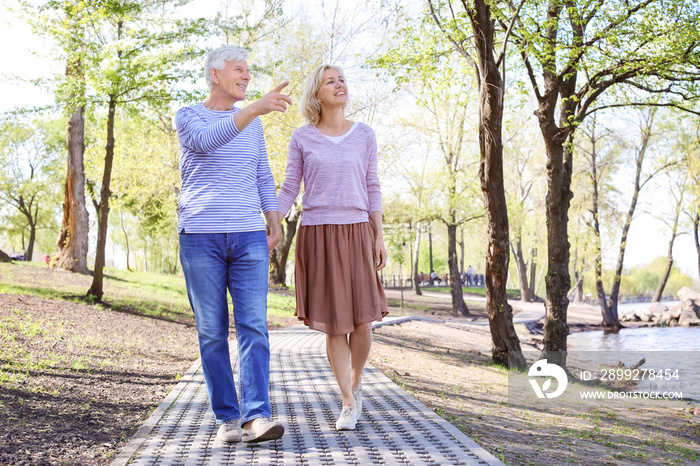 Mature couple walking in park on spring day