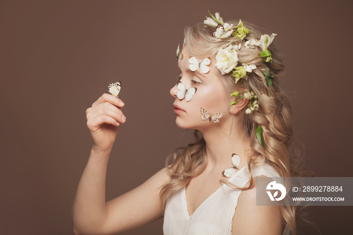 Beautiful young beauty. Beautiful blonde woman with butterflies and flowers