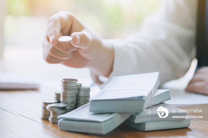 Businessman analyzing investment charts and pressing calculator buttons over documents. Accounting Concept.