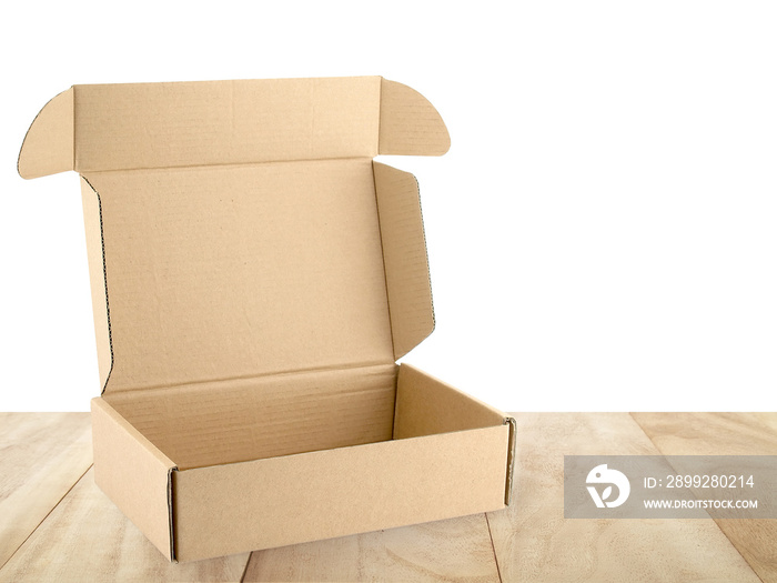 open empty flap brown beige carton box on wooden table counter isolated on white background, close up single cardboard parcel box for packages delivery, recyclable paper packaging