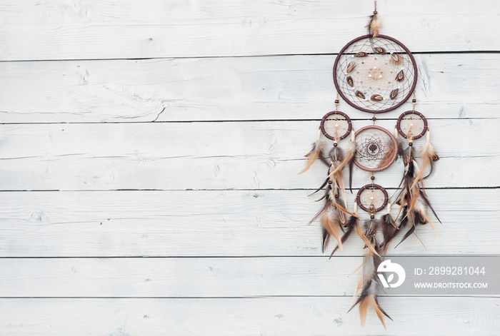 Dreamcatcher, american native amulet on wooden background. Shaman