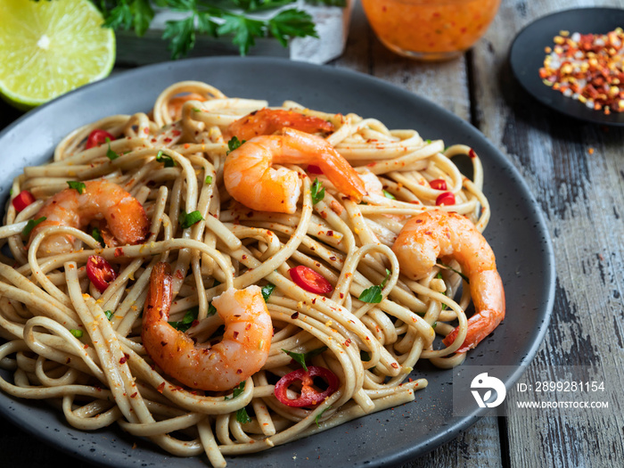 noodles pasta with shrimp , spice , on the plate. Closeup.