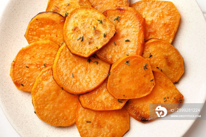 Plate with tasty cooked sweet potato on table close up