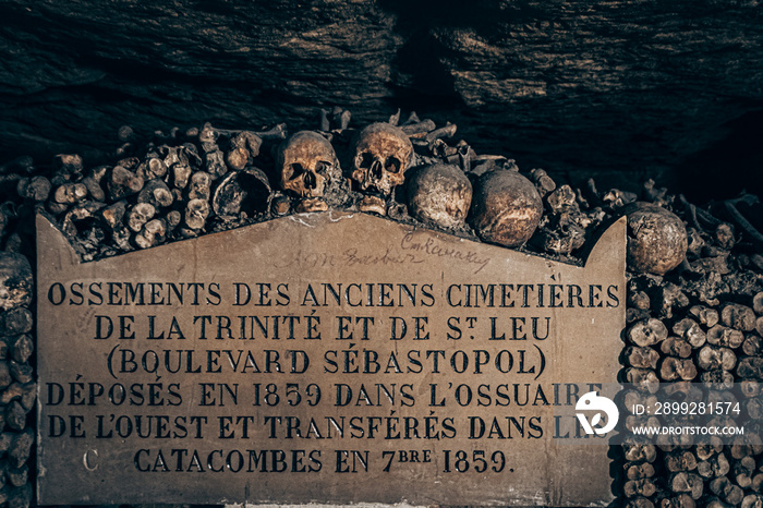 underground catacombs full of bones, gravestones and inscriptions