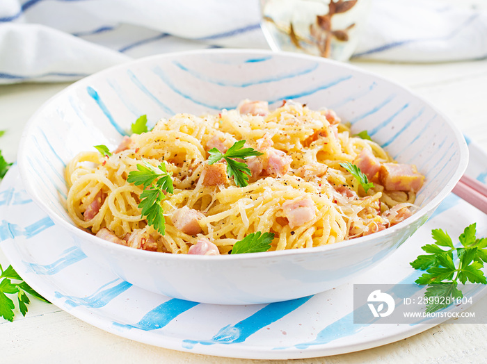 Classic homemade carbonara pasta with pancetta, egg, hard parmesan cheese and cream sauce. Italian cuisine. Spaghetti alla carbonara.