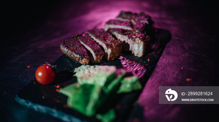 sliced ​​steak in neon light