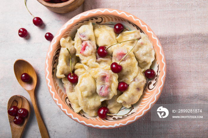 Preparing dumplings with cherry. making pierogi or pyrohy, varenyky. Traditional Russian cuisine, or  Ukrainian hand-made vareniki