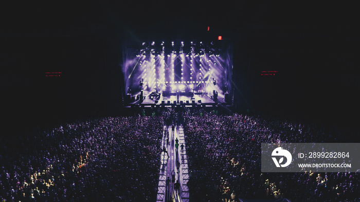 Aerial view on the stage. Music Festival. Crowds of people. Evening. Night. Dark.