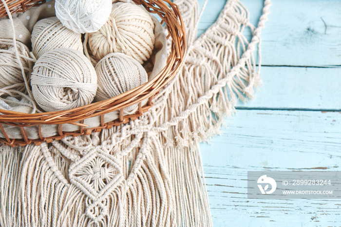 Handmade macrame braiding, background thread on a wooden Board top view