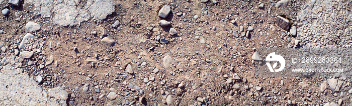 Destroyed asphalt cover on road. Bad road condition that needs repair. Banner size, top view