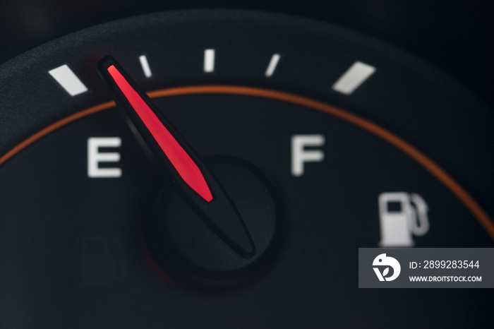 Close-up car dash board petrol meter on black background.