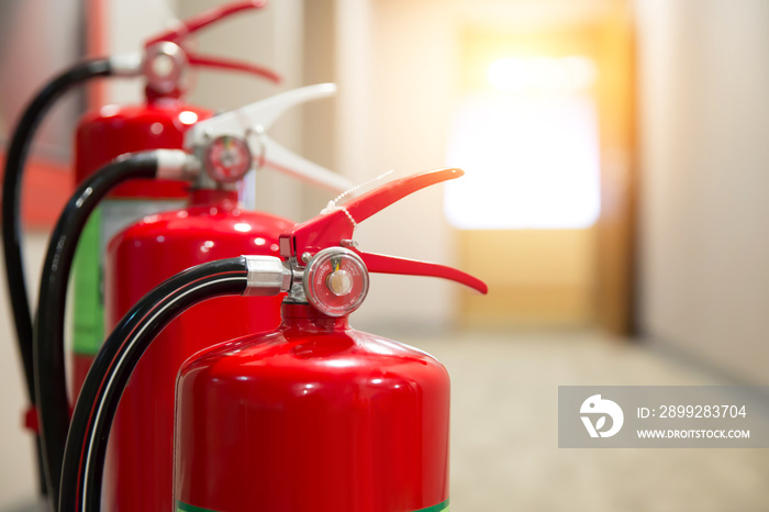 Red Fire extinguishers in the building,Engineers are checking fire extinguishers.