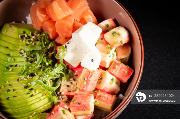 salmon and crab gohan salad served in a bowl