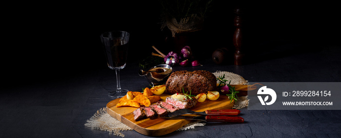 rustic medium butter beef steak with herbs and potato wedges