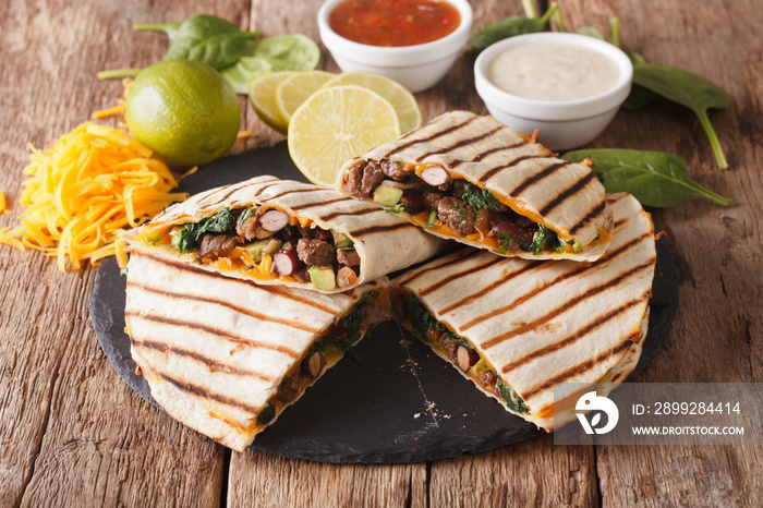 Mexican quesadilla with spinach, beans and cheddar cheese close-up. horizontal