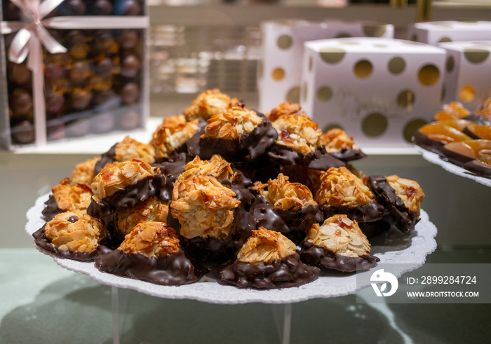 Gourmet almond and dark chocolate Florentine biscuits  on display in the pastry shop.