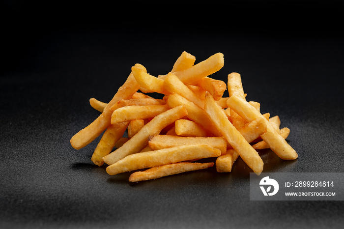 Pile of french fries over black background