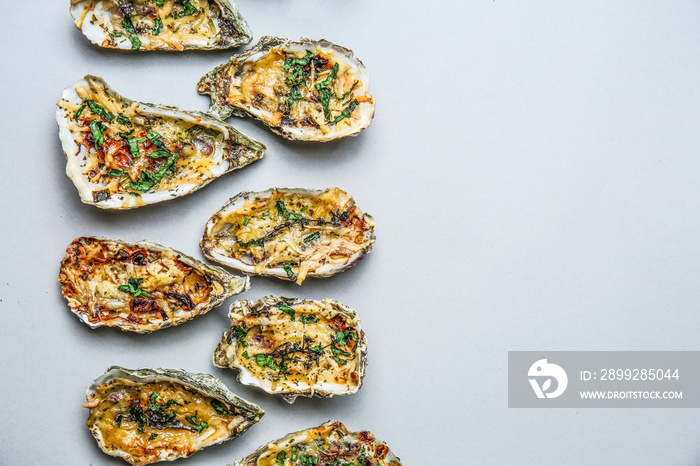 Tasty baked oysters on grey background