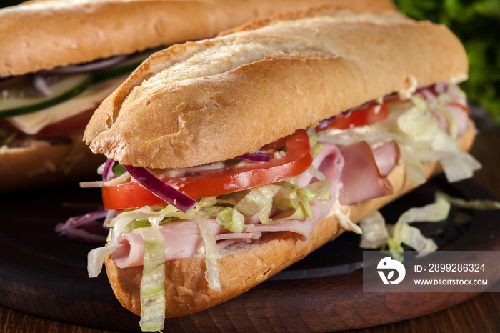 Submarine sandwiches with ham, cheese and vegetables