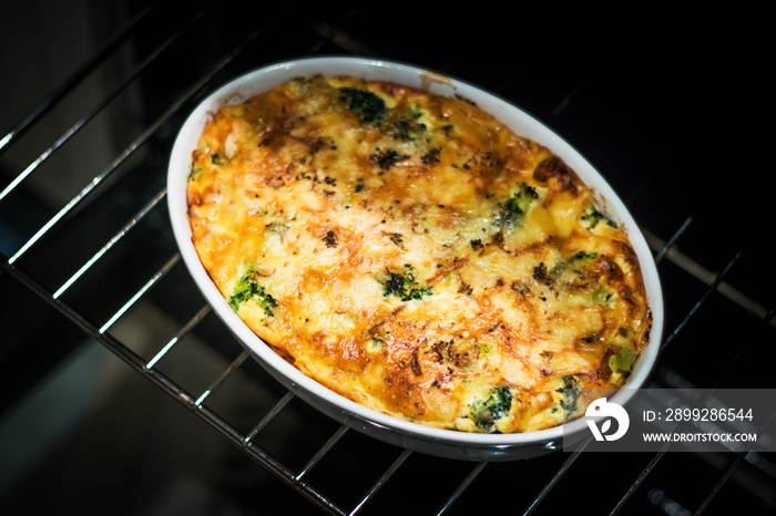 Casserole with broccoli and cheese right from the oven, true looking