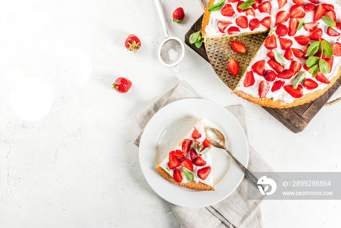 Homemade biscuit cake with whipped cream, fresh organic raw strawberries and mint. On a white stone table. Copy space top view